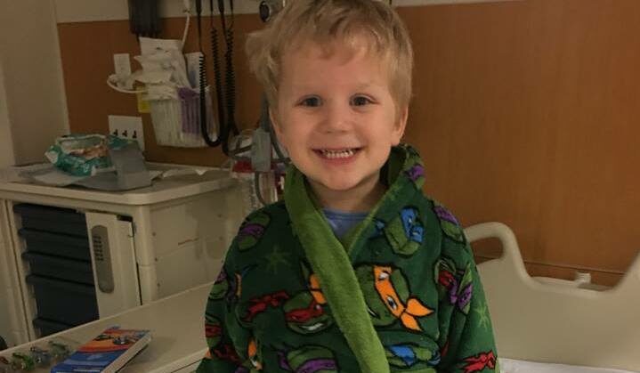 boy smiling in hospital bed