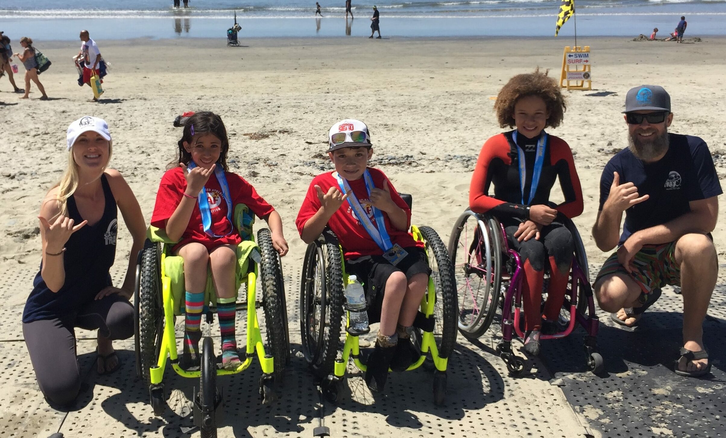 happy wheelchair users at beach