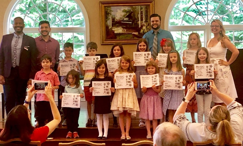 group holding their certificates from Atlanta Music