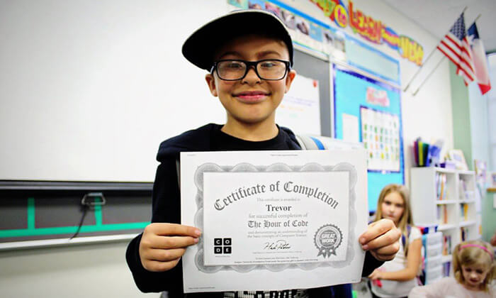 boy proudly holding certificate