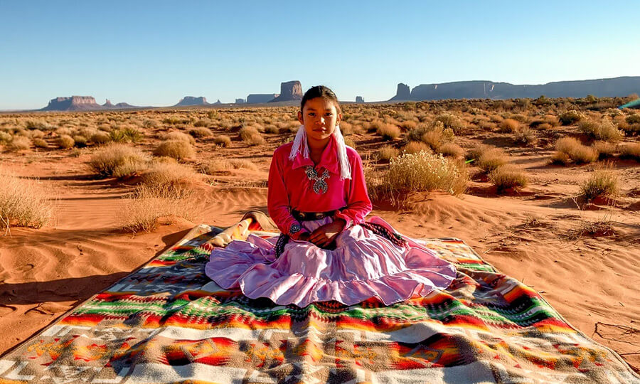 Native woman sitting in desert