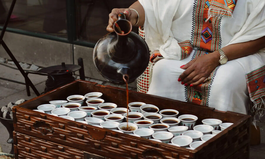 Pouring Ethiopian coffee into cups
