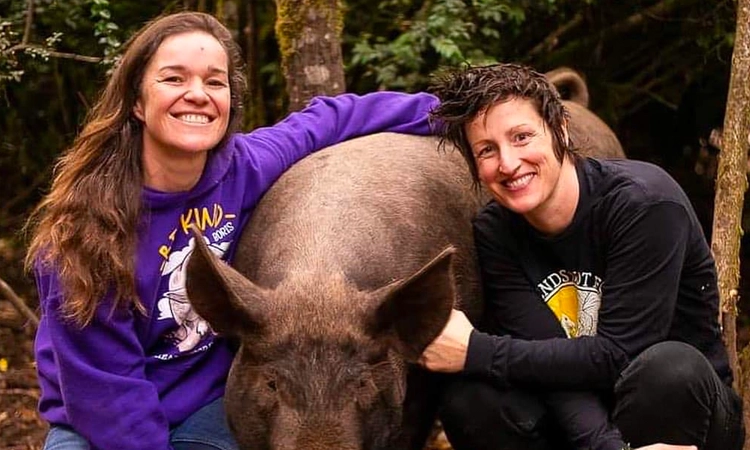 Kate and Hope with rescued pig