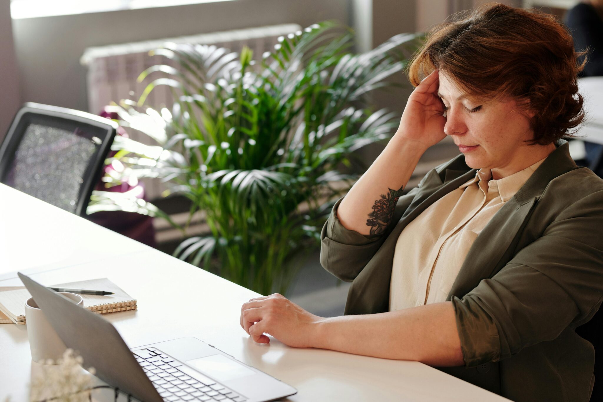 tired woman sitting with her laptop